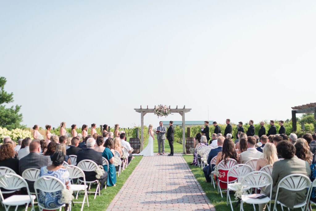 a wide open view of a wedding ceremony at The Barn & Vineyard